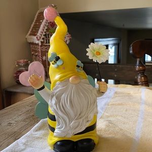 Gnome with wings holding a daisy spring decor resin material